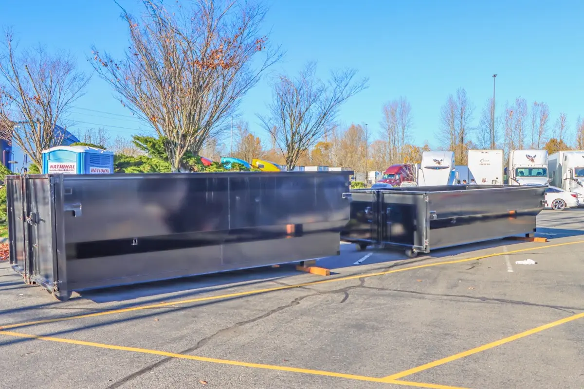 Professional dumpster rental service with roll-off container on residential driveway in Imperial Beach